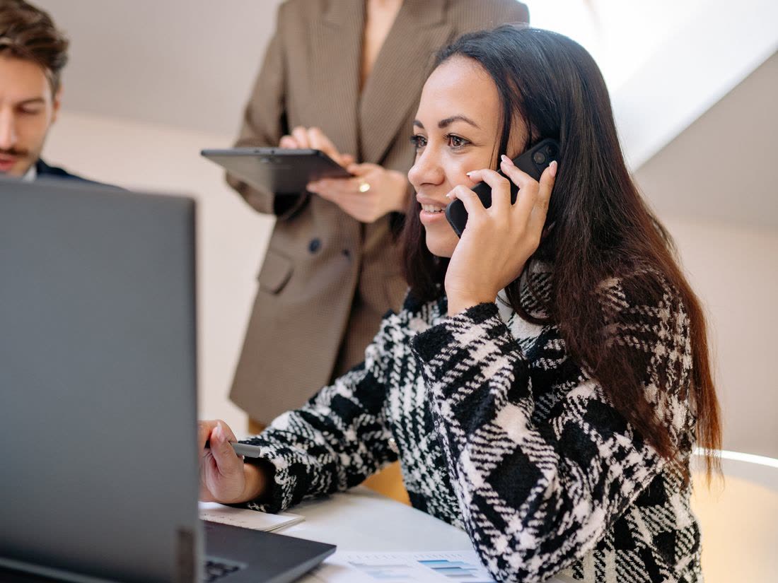 A professional taking a call while working