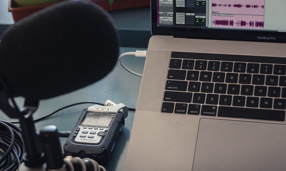 A microphone and laptop set up for recording