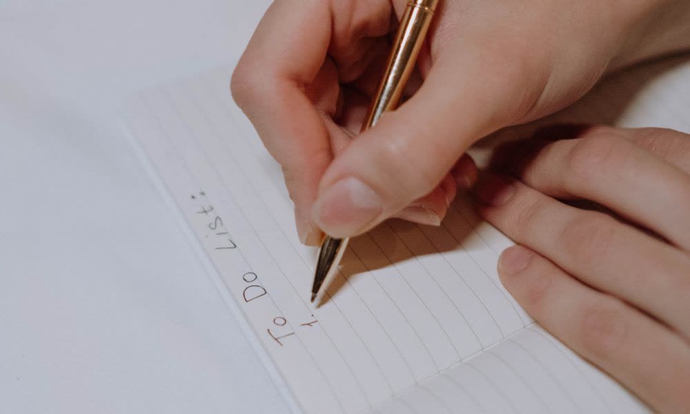 Writing a to-do list in a notebook